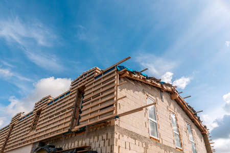 New residential construction home framing against a blue sky. Roofing construction.