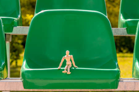 Wooden spectator sitting in stadium in front of sports groundの写真素材