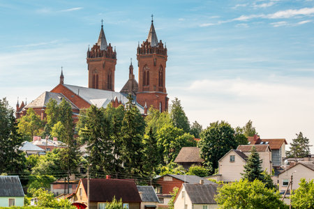 Scenic view of roofs of small houses and tall church with bell towersのeditorial素材