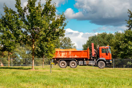 Heavy dump truck transporting sand at construction site