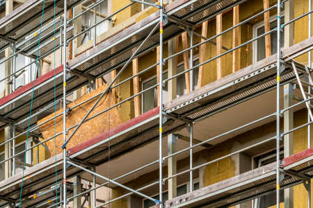 Renovation of the facade of a multistorey building.Scaffolding standing against the wall of multistorey building.の写真素材