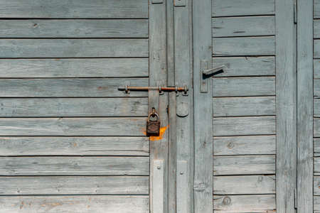 Old grey wooden door of the barn or garage