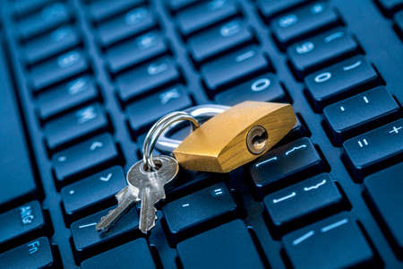 Computer security concept. Locked padlock on laptop keyboard. Security lock on computer keyboard -...