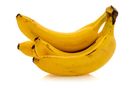 Ripe yellow bananas, which are a great source of magnesium, vitamin B6, and vitamin C. Isolated on white background.の写真素材