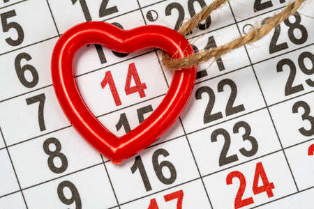 Memorable cute heart pendant on the February monthly calendar. Valentine's day backgroundの写真素材
