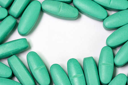 Medical pills spilled on white background. Copy space.の写真素材