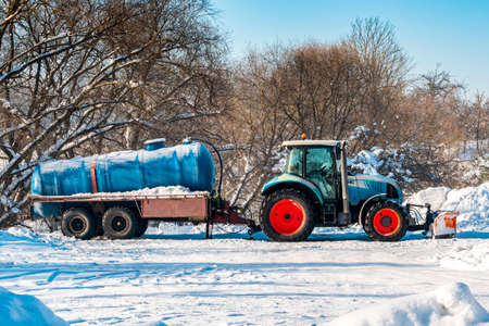 Tractor with tanker for cleaning the sewer system. Winter season.の写真素材
