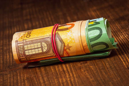 Roll of euro currency banknotes with a rubber band