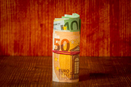 Roll of euro currency banknotes with a rubber band