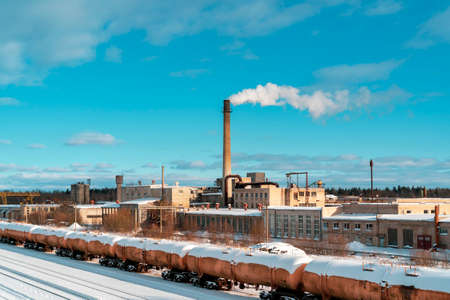 Aerial view of freight train. Railway station with wagons. Heavy industry. Industrial landscape with train in depot, chimney with smoke stack, factory buildings.の写真素材