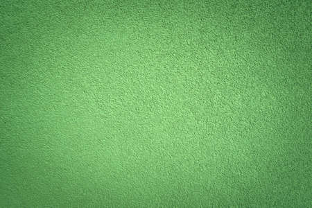 Decorative green texture of plaster on the wall as a background of the embossed surfaceの写真素材