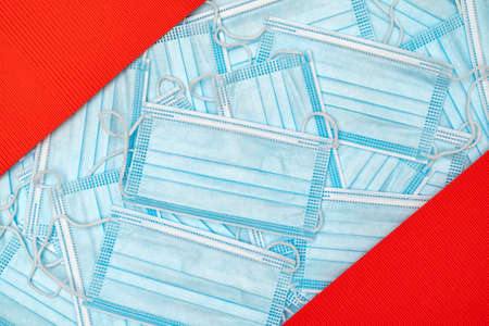 Medical face mask for against the corona virus, covid-19. Typical 3-ply surgical mask to cover the mouth and nose. A lot of medical protective masks with red frame.の写真素材