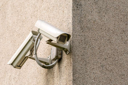 Two CCTV cameras on grey concrete wall. CCTV security system.の写真素材