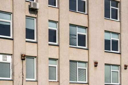 Windows of classic facade of the abandoned office building
