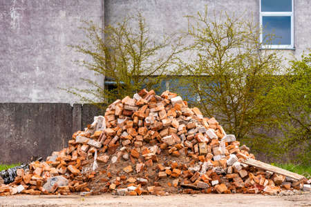 A pile of construction waste. Building rubble and stones. Abandoned garbage, junk, garbage piled up...