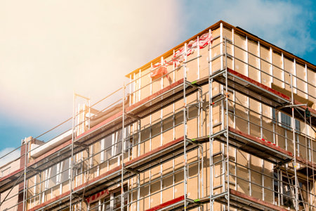 Renovation of the facade of a multistorey building.Scaffolding standing against the wall of multistorey building.の写真素材