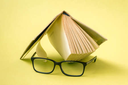 Wisdom and knowledge. Reading a books. Eyeglasses laid up on an old books.の写真素材