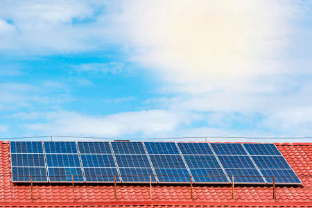 House with solar panels on top of roof. Electricity reduced from solar panel installation.