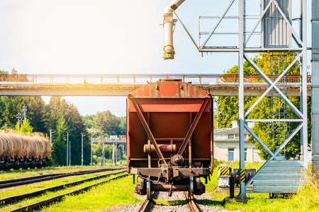 Loading railway carriages with grain at grain elevator.
