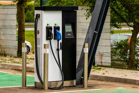 Modern electric car charging station at parkingの写真素材