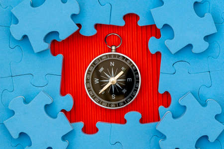Composition of Jigsaw Puzzle  and Compass. Business strategy concept.の写真素材