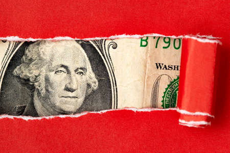 President Washington looks through a hole red ripped paperの写真素材