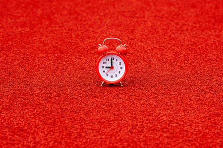 Fitness concept,  alarm clock on the outdoor sports stadium, healthy lifestyle, morning trainingの写真素材