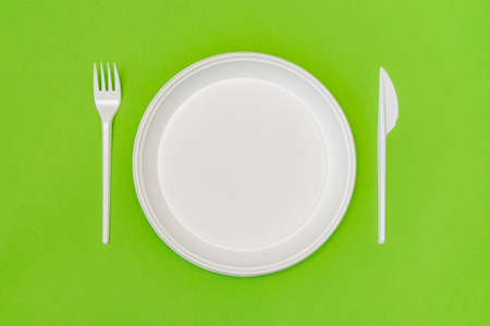 Set of white disposable tableware on the green backgroundの写真素材