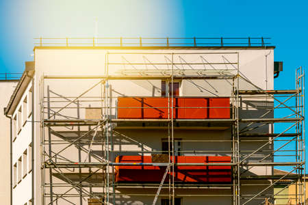 Scaffolds erected around  multi storey house to allow safe acces to place of work, renovation of the facadeの写真素材