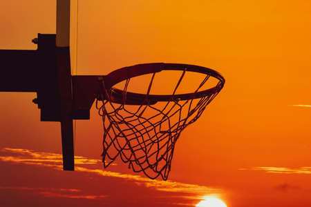 Basketball hoop silhouette. Basketball hoop in the outdoor basketball court during sunset