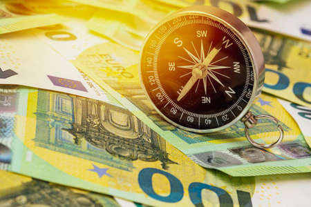 Black compass on euro banknotes. Europe economy direction, financial or investment conceptの写真素材