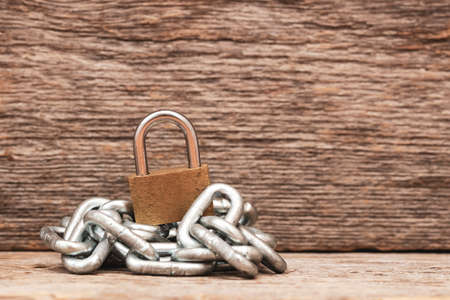 Padlock on pile of metal chain. Safety,property protection, symbolic security.の写真素材