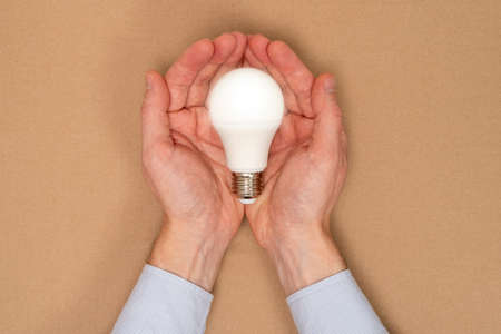 Hands holding light bulb. Idea concept with innovation and inspiration