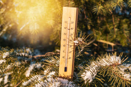 Outdoor thermometer reaches minus 10 ten degrees. Winter background with thermometer on frosty day.