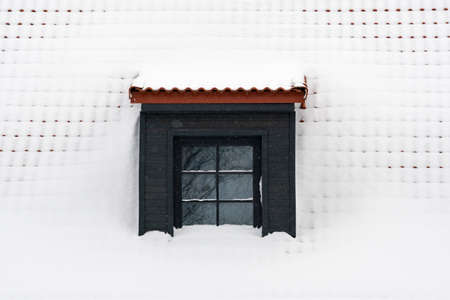 Dormer on a roof under a layer of fresh snow