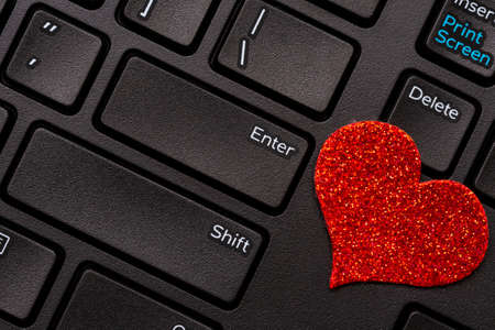 Love on the Internet. Concept with a Laptop Computer Keyboard and Little Red Heart.の写真素材
