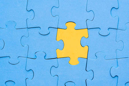 Yellow jigsaw puzzle piece stands out from the crowd. Diversity, unique or difference concept.の写真素材