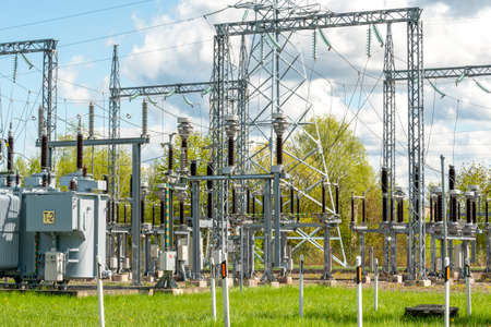 Electricity substation with cloudy sky background. High voltage distribution system. High voltage...