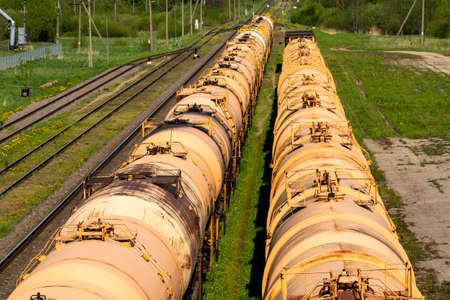 Set of tanks with oil and fuel transport by rail. Freight cars and trains on the railway