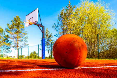 Basketball ball on the street court with hoop on the background. Sport equipmentの写真素材