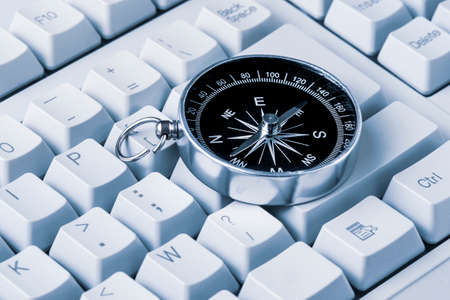 The Internet Navigator Concept . Old Metallic Compass on the Computer Keyboard. Navigation Through the Internet.の写真素材