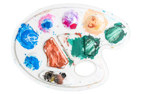 Art palette with stains of watercolor paint. Isolated on white background.