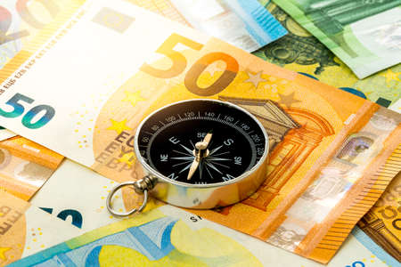 Black compass on euro banknotes. Europe economy direction, financial or investment conceptの写真素材