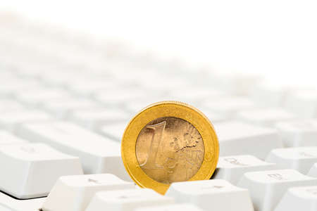 Euro coin on computer keyboard background. Close-up view.の写真素材