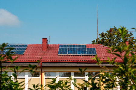 Photovoltaic or solar panels on a red roof. Production of renewable energy concept.の写真素材