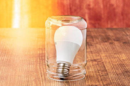 Light bulb inside glass jar. Energy saving concept. Preserve creativity concept and preserving...
