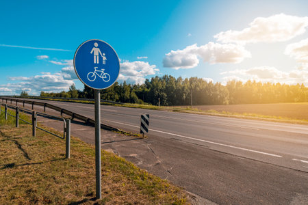 Bike and pedestrian lane sign post on way side of highwayの写真素材