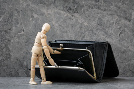 Dummy opening empty ragged leather wallet, searching for money. Social problem, poverty and misery conceptの写真素材