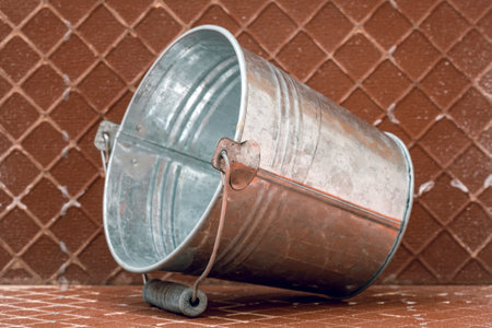Metal bucket on the reverse side of the ceramic tile.Home improvement, renovation.の写真素材
