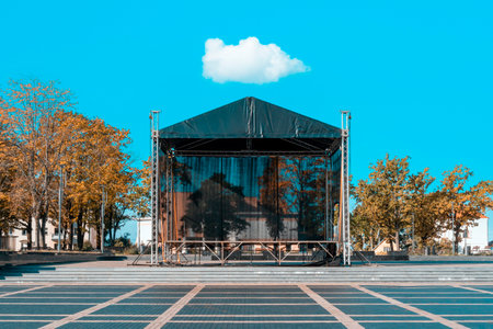 Autumnal city square with a concert venue stage. Empty performing stage.の写真素材